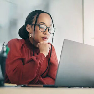 professional woman stares intently at laptop screen